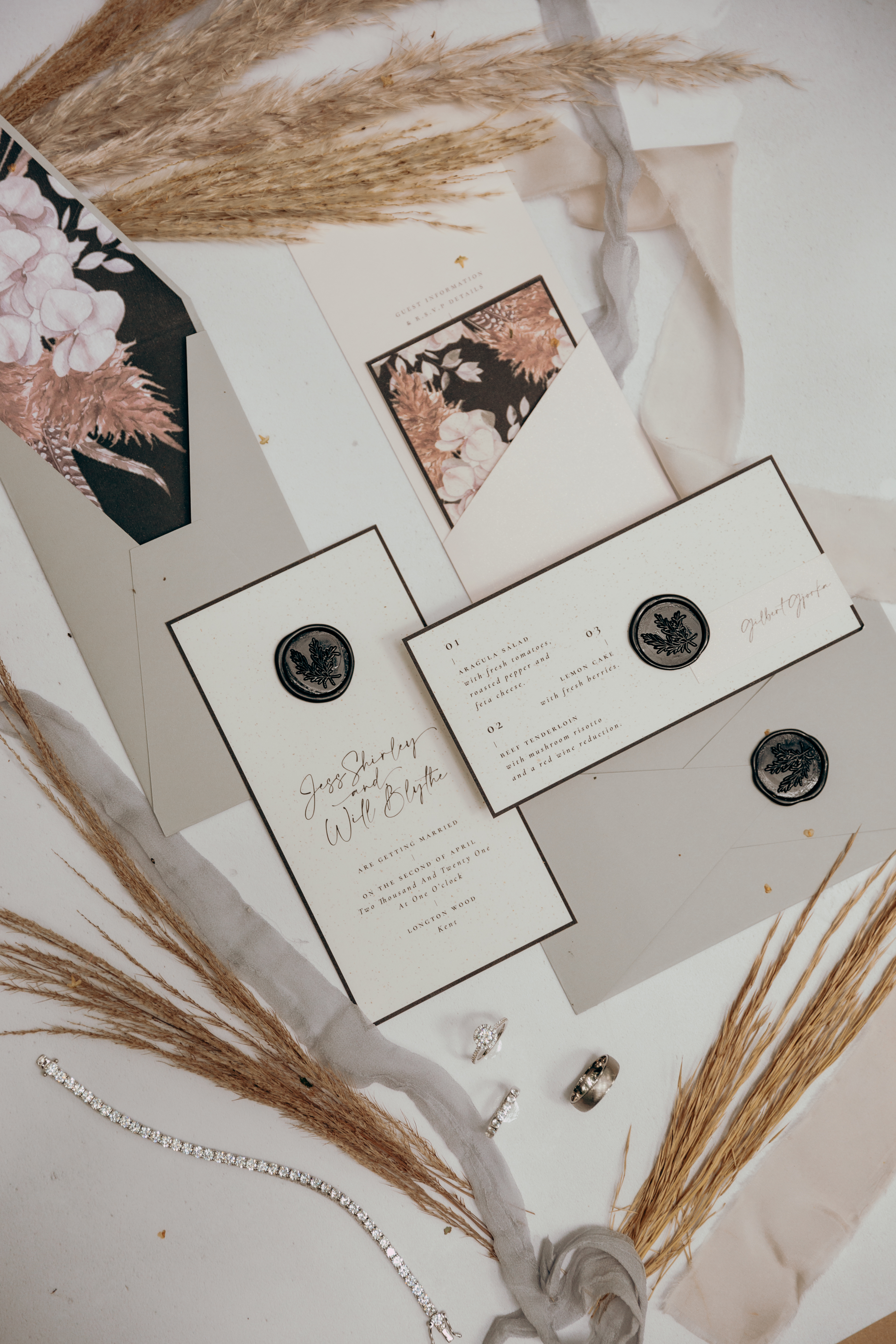 A flatlay with pampas grass and black and white stationery
