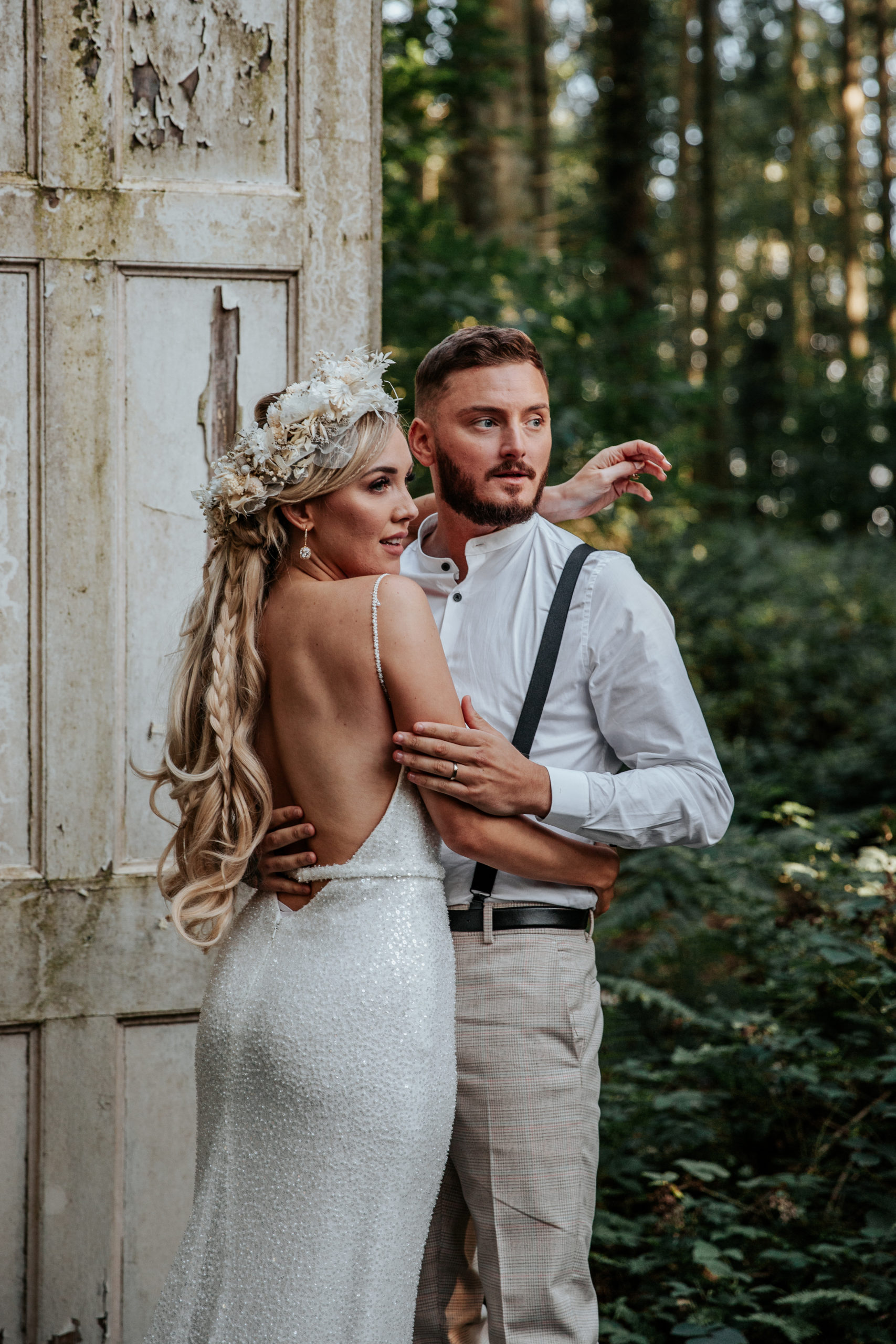 Will and Jess embrace at golden hour infront of Longton Wood's white doors