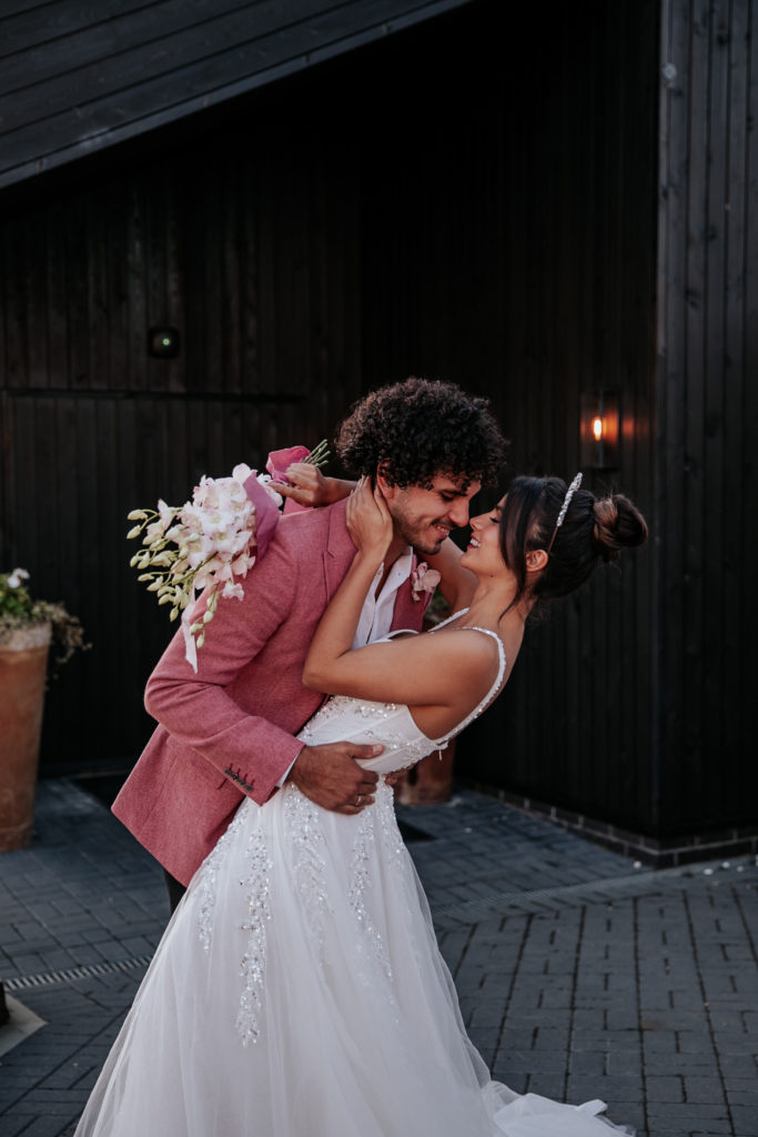 Taco and Arepa stood out the front of Botley Hill's main barn. Taco wears a pink suit jacket while Arepa wears a wedding dress