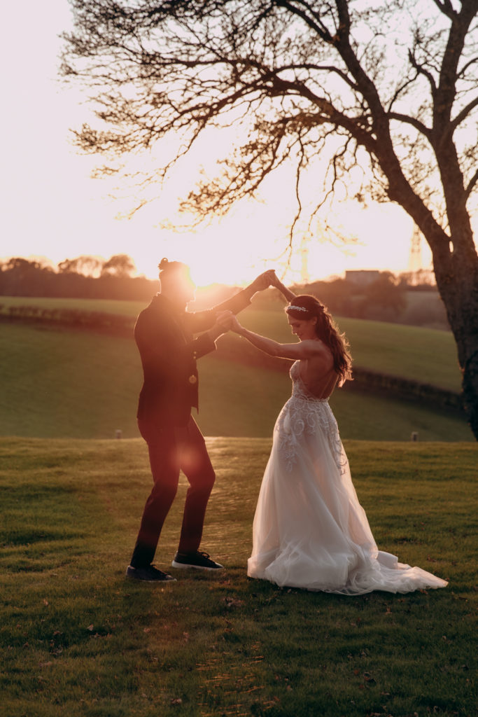 Tomina and Jacob dance out in the gardens of Botley Hill Barn in golden hour