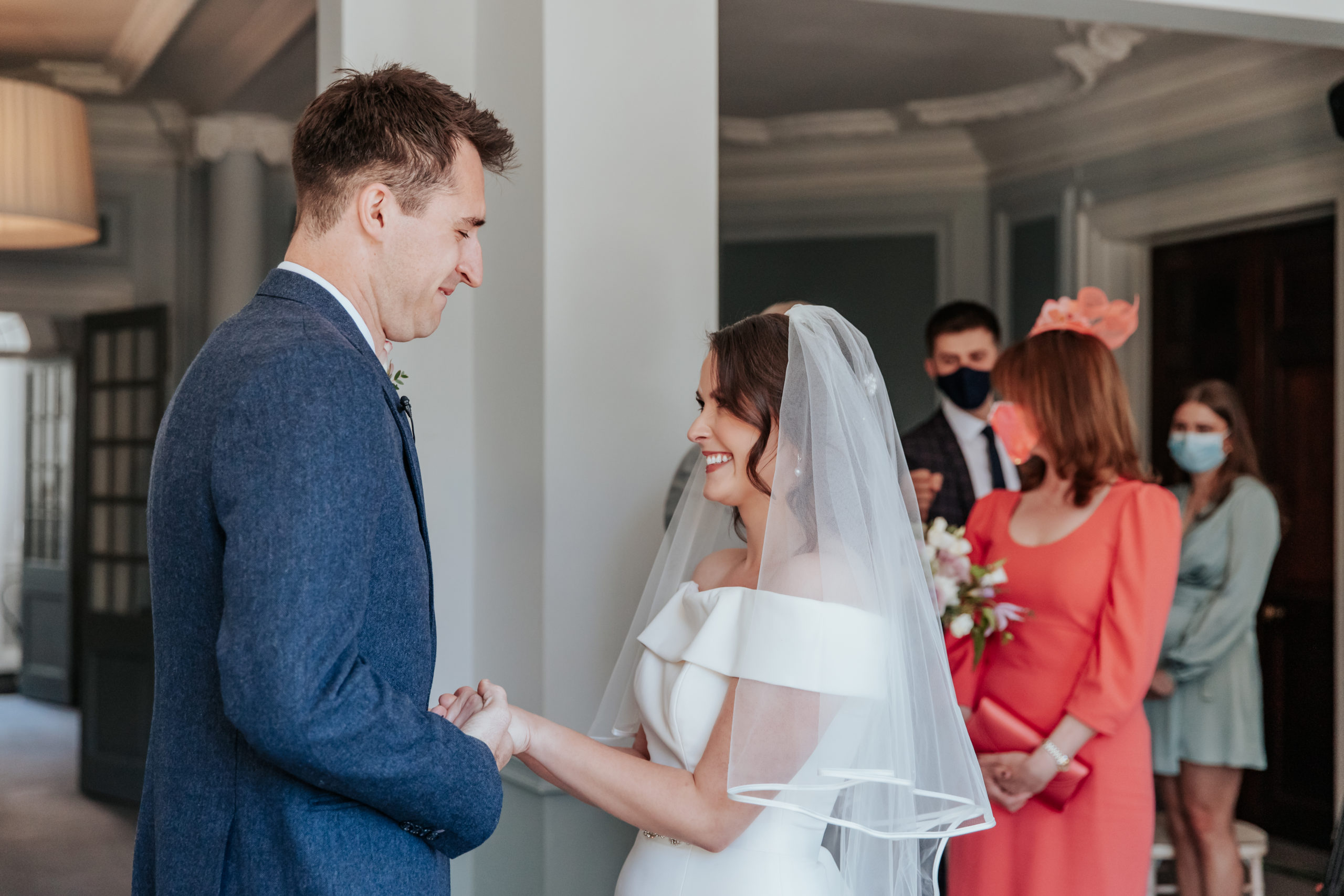 Laura and Stuart hold hands during their wedding