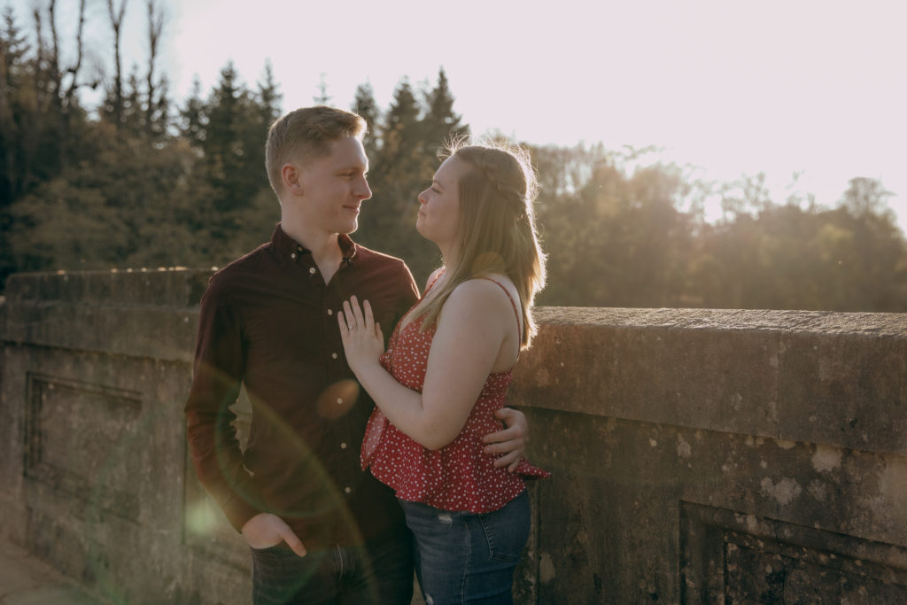 Toby and Jemma stood on the stone bridge in Virginia Waters during their spring engagement shoot