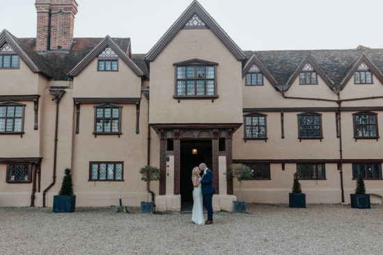 Anna & Rich stand in front of the Ufton Court manor house