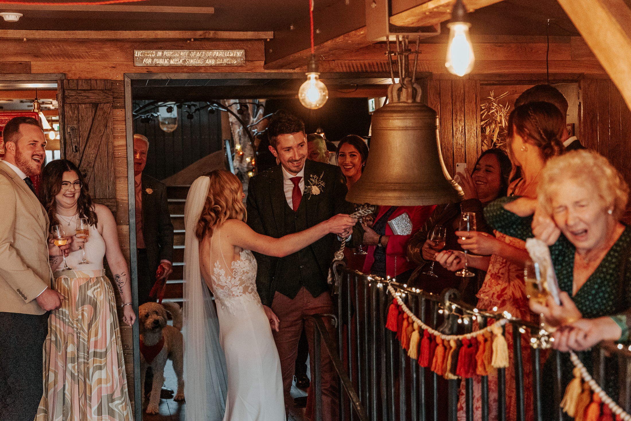 Maddie and Will ring a bell while a lady covers her ears