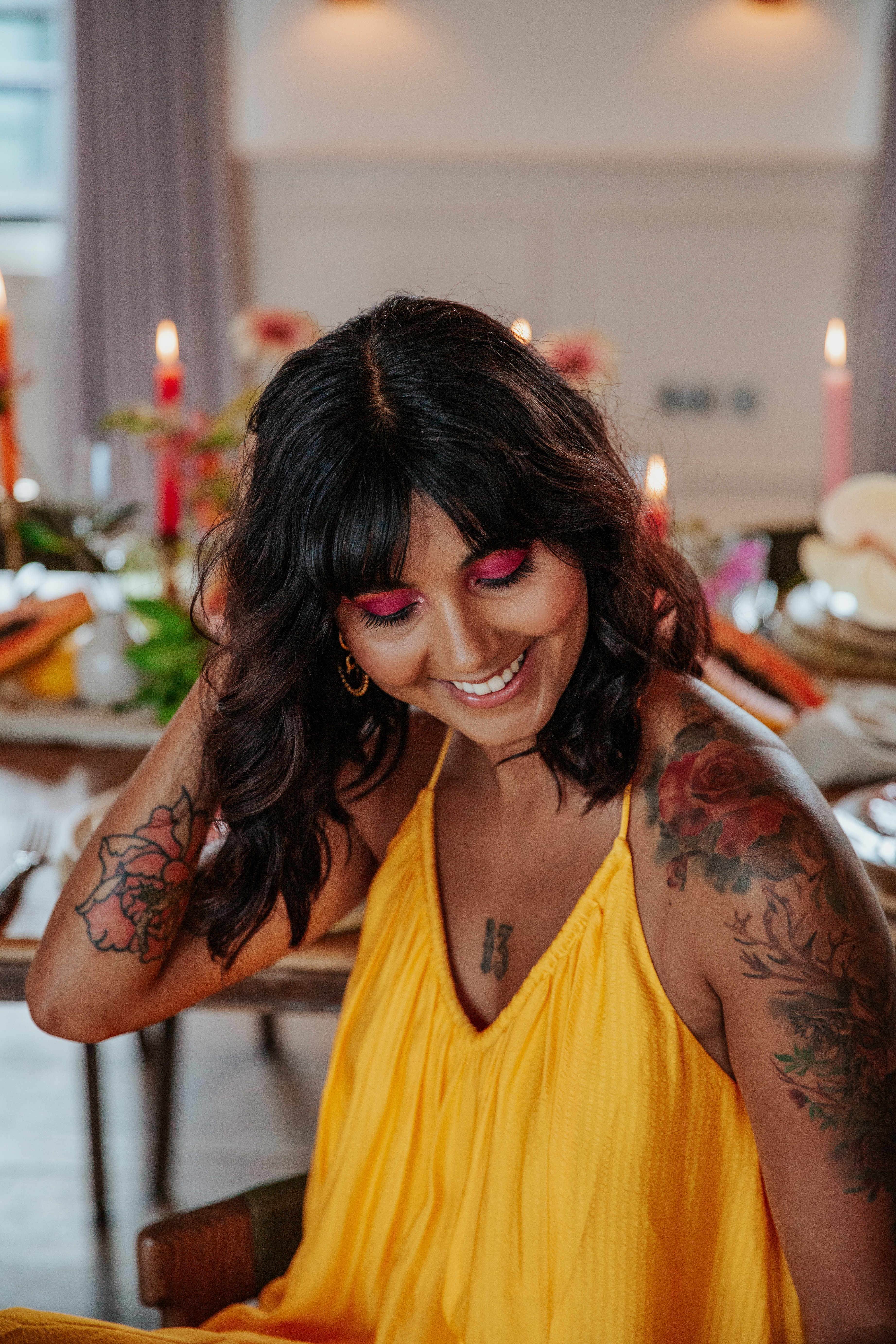 Meera looks down and smiles, tucking her hair behind her ear