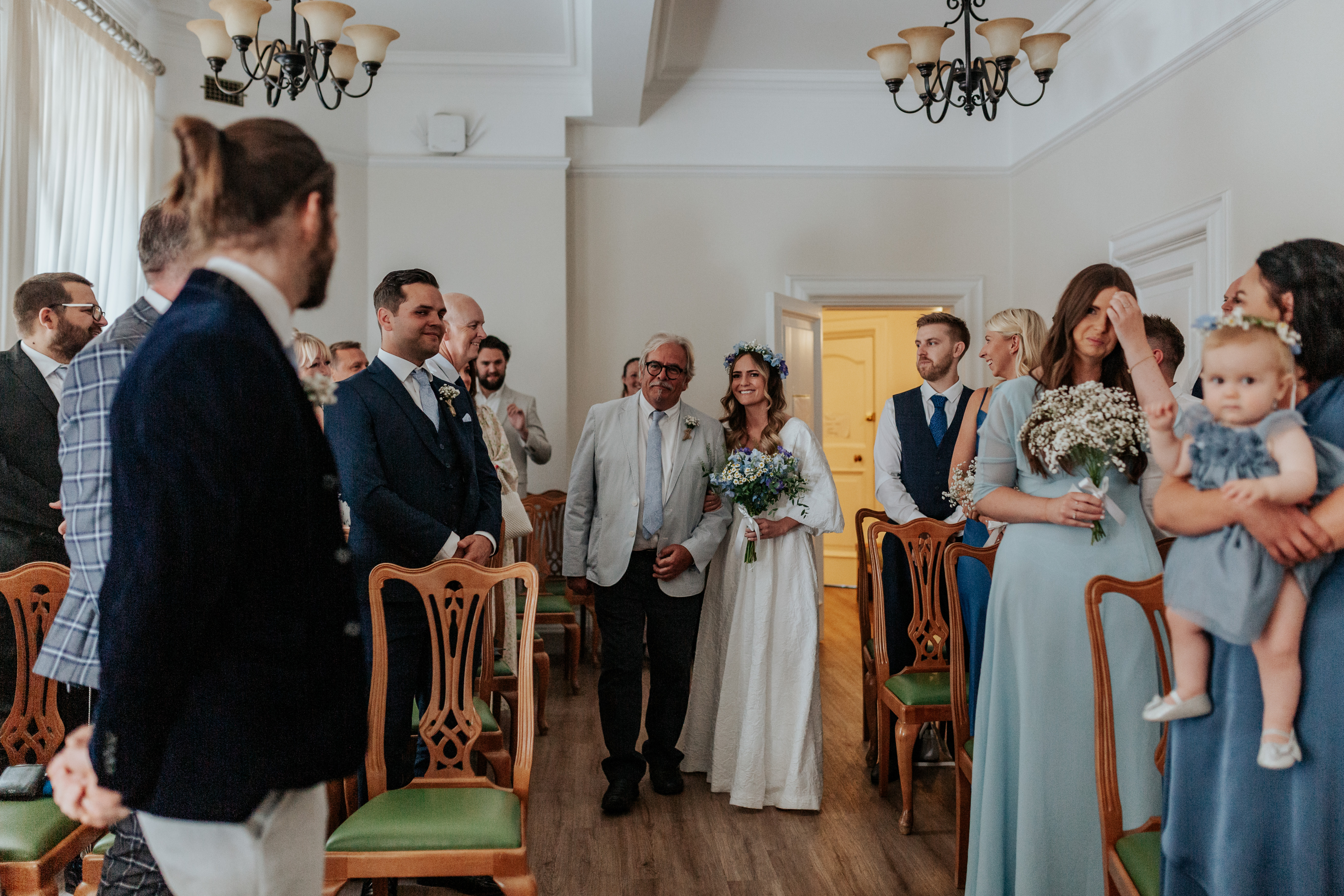 HannahSam25_07-033 Bride walks down the aisle with her father in the Edwardian Room of Woolwich Town Hall