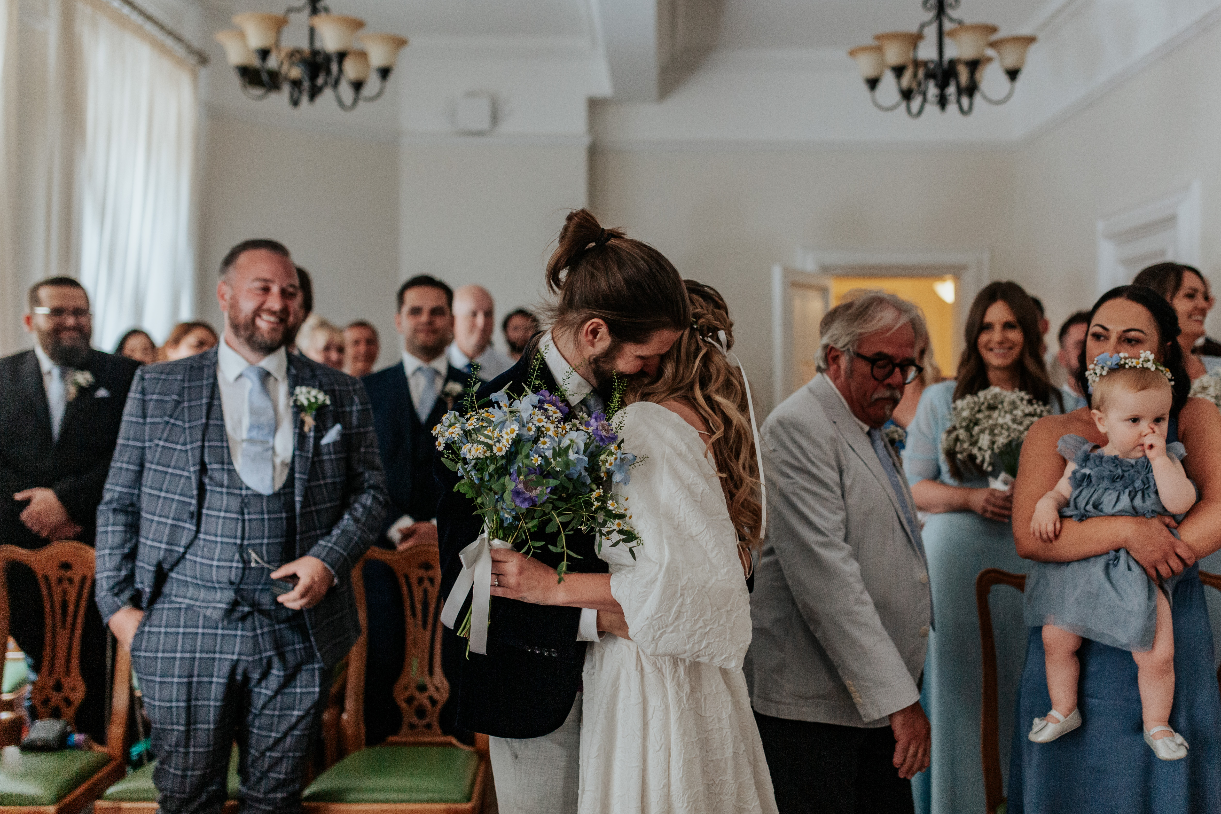 HannahSam25_07-041 Bride and groom embrace at the start of their London wedding ceremony at Woolwich Town Hall