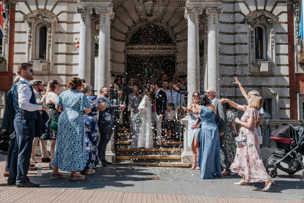 A group confetti shot at a London wedding outside Woolwich Town Hall