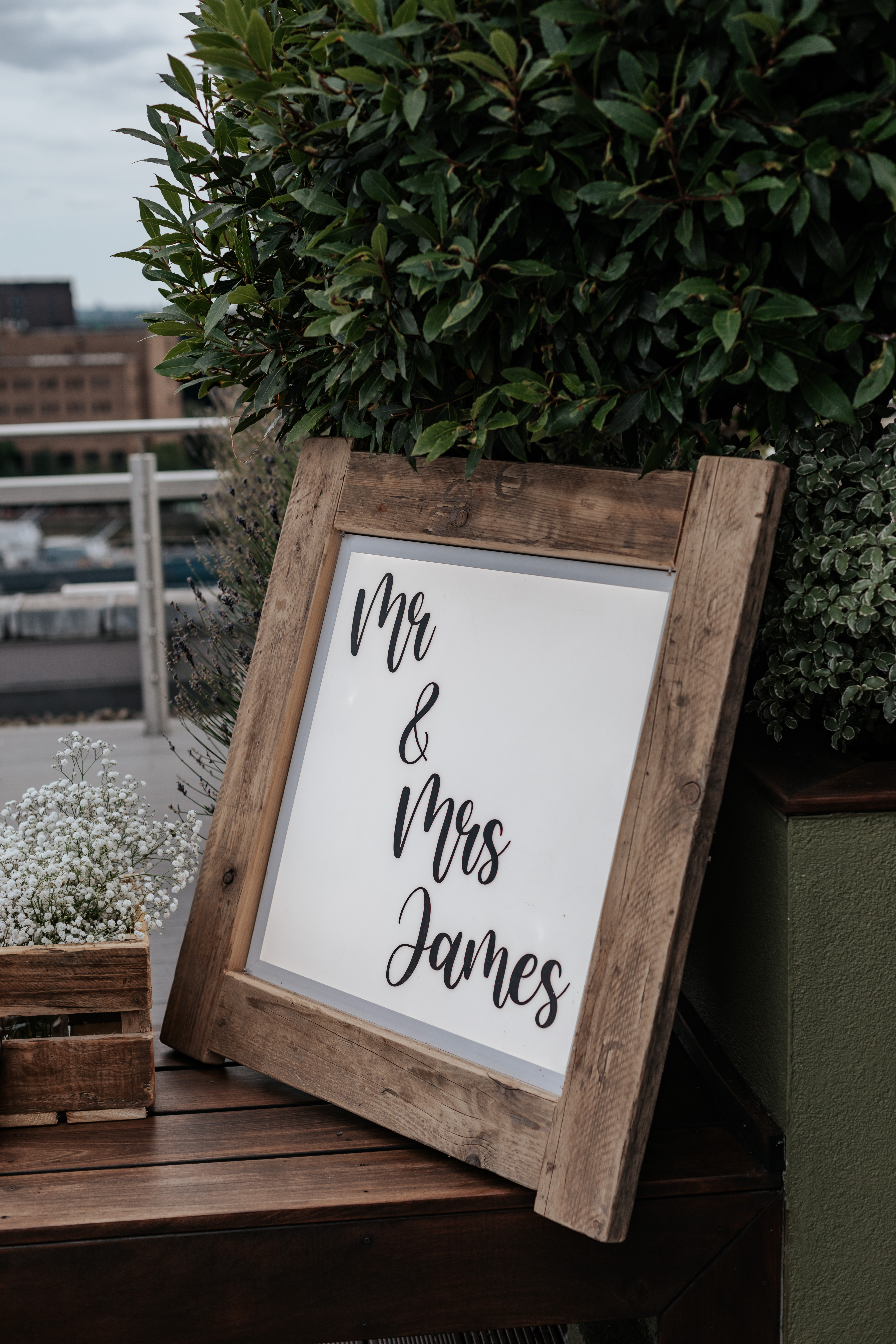 HannahSam25_07-155 A light-up wooden sign that says 'Mr & Mrs James'
