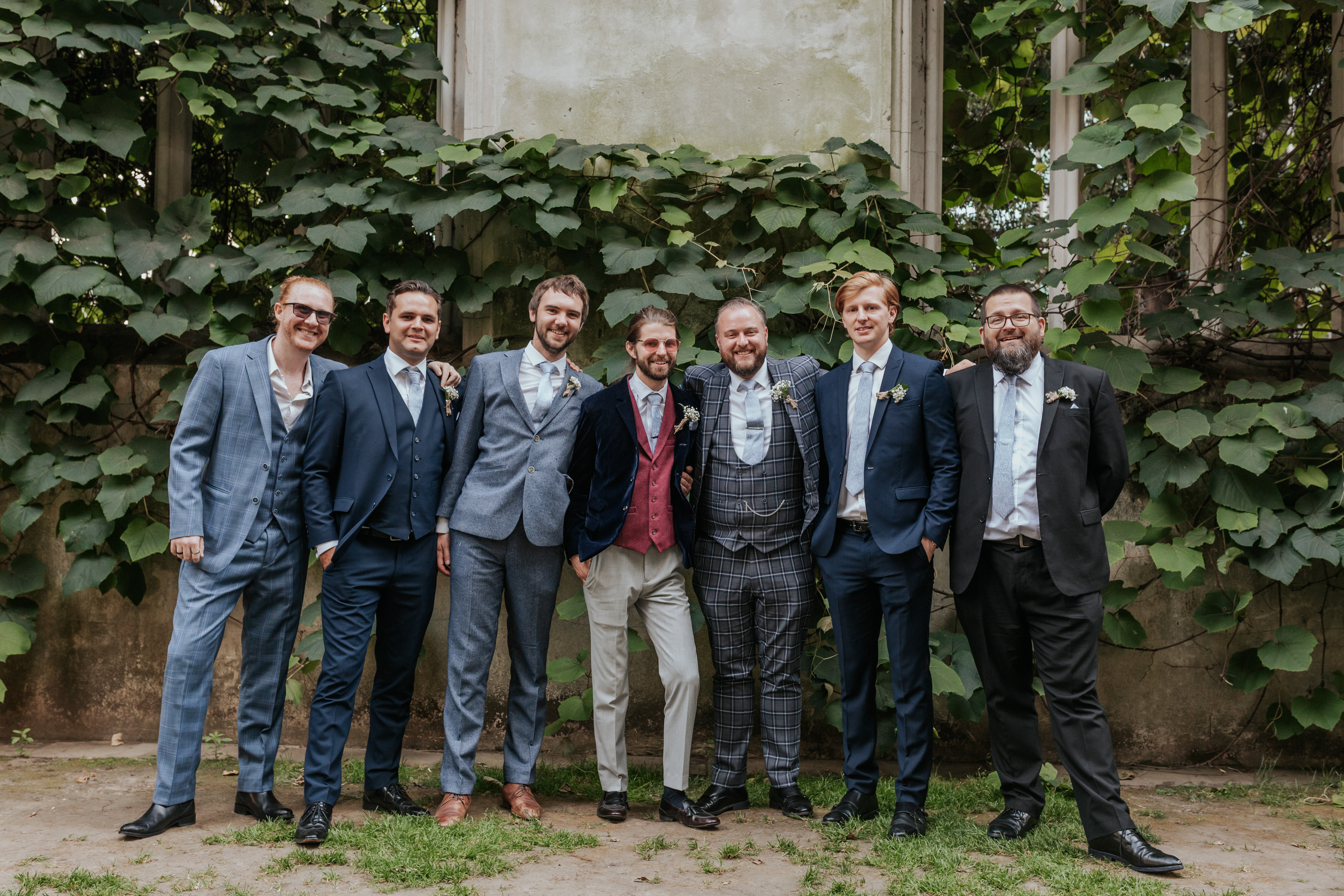 HannahSam25_07-239 The groom and his groomsmen stand together at St Dunstans in The East gardens