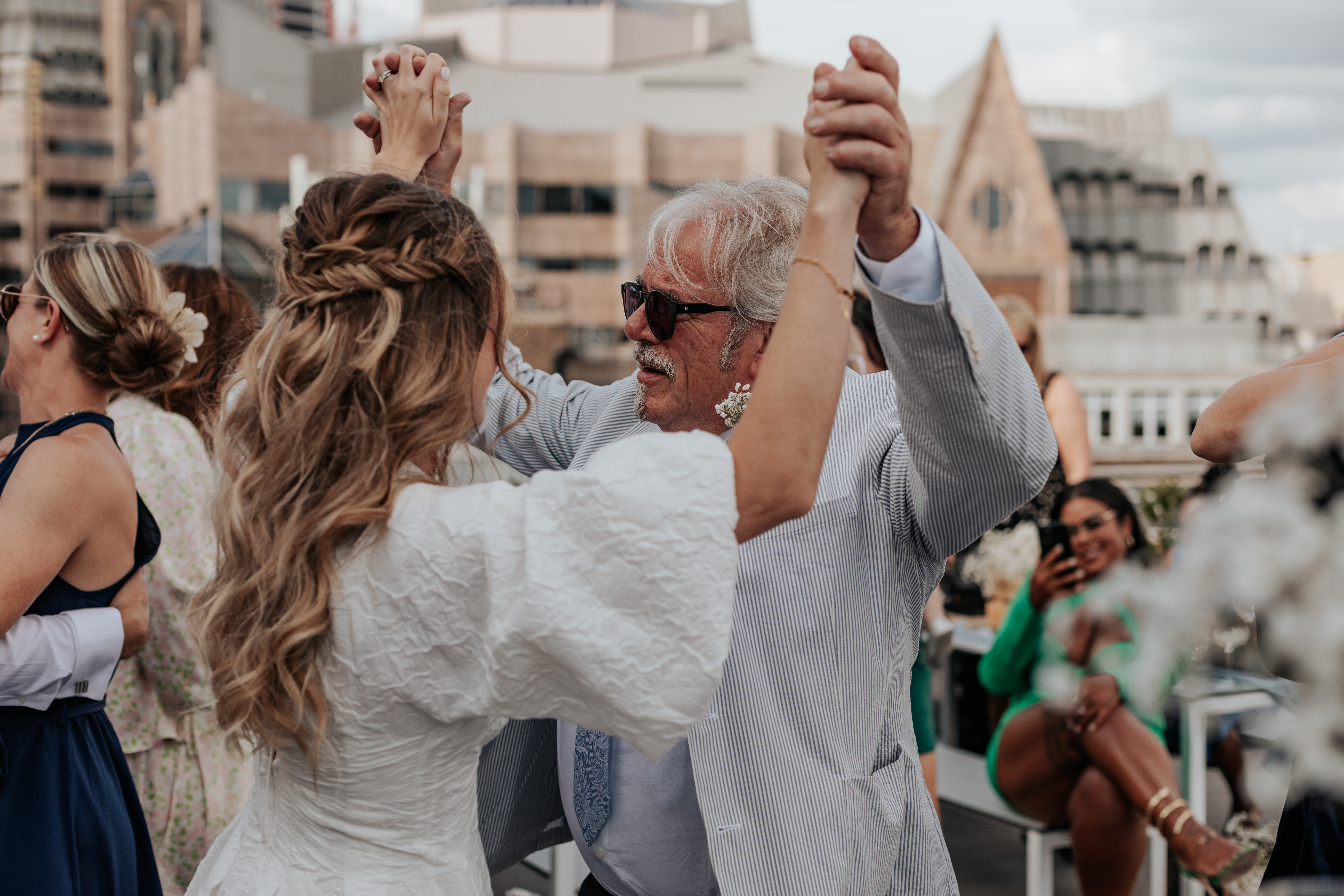 HannahSam25_07-327 Bride dances with her dad on the rooftop terrace of a London bar