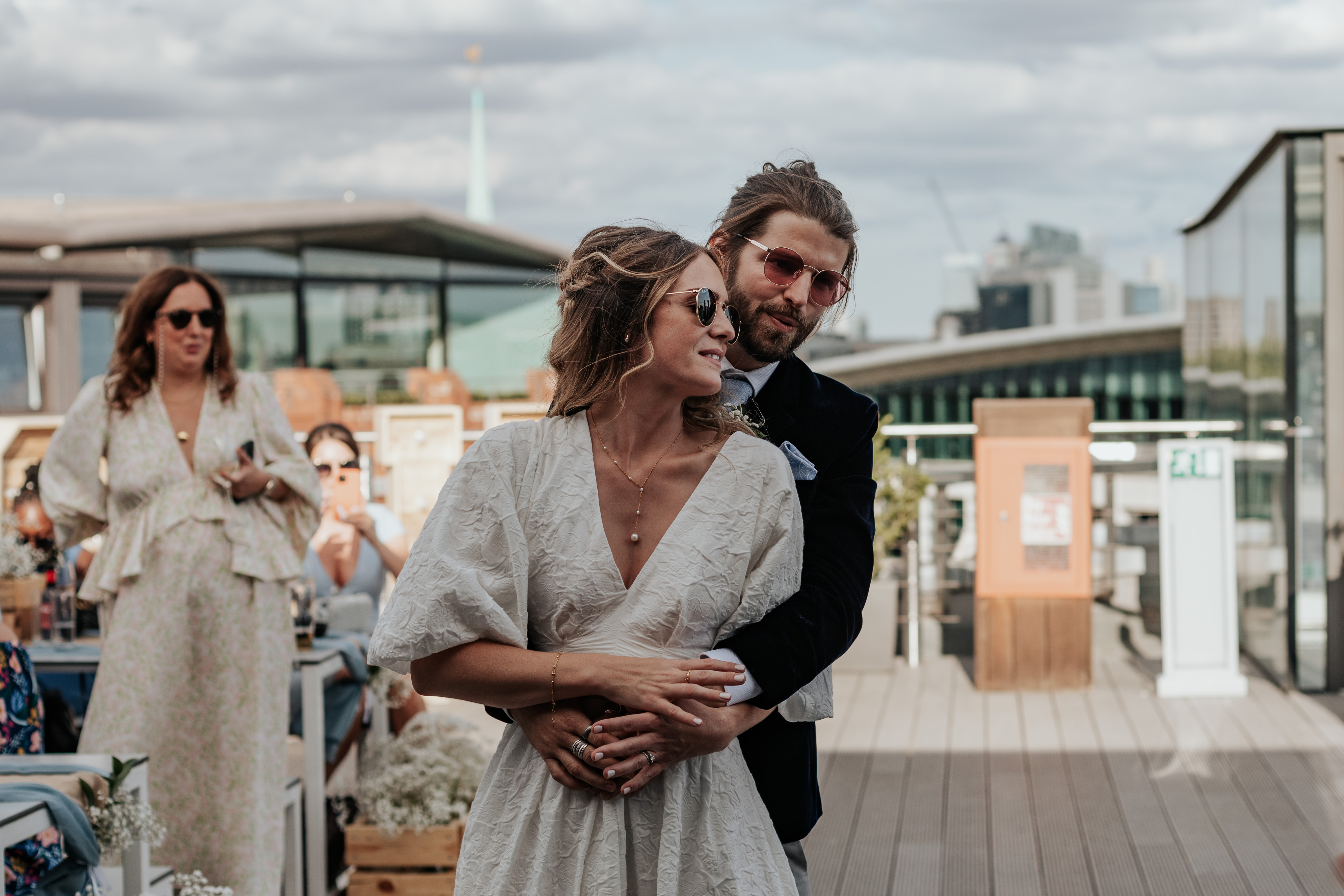 HannahSam25_07-349 Bride and groom dance together on the rooftop terrace of a London bar