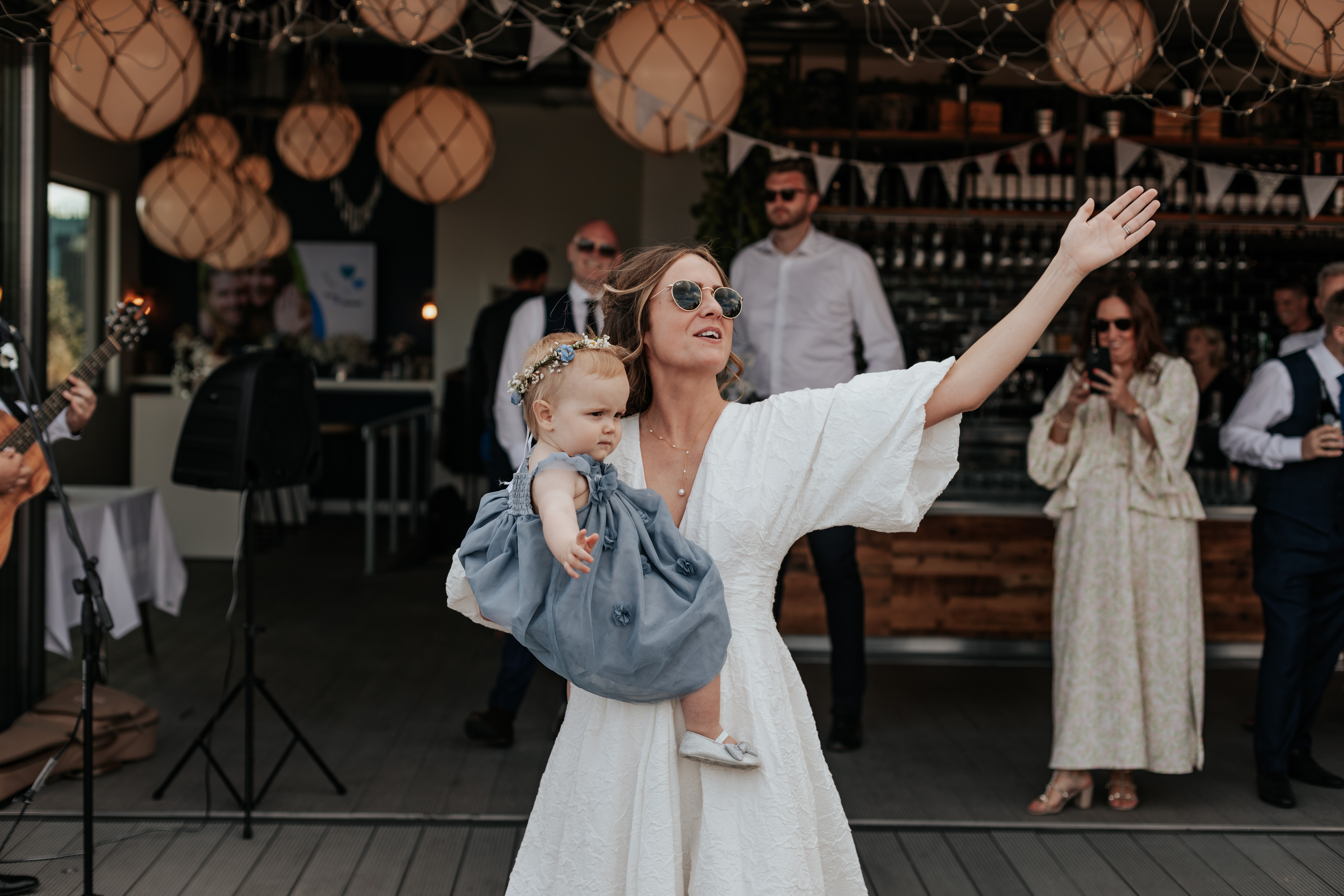 HannahSam25_07-352 Bride dances with her daughter on the rooftop terrace of a London bar