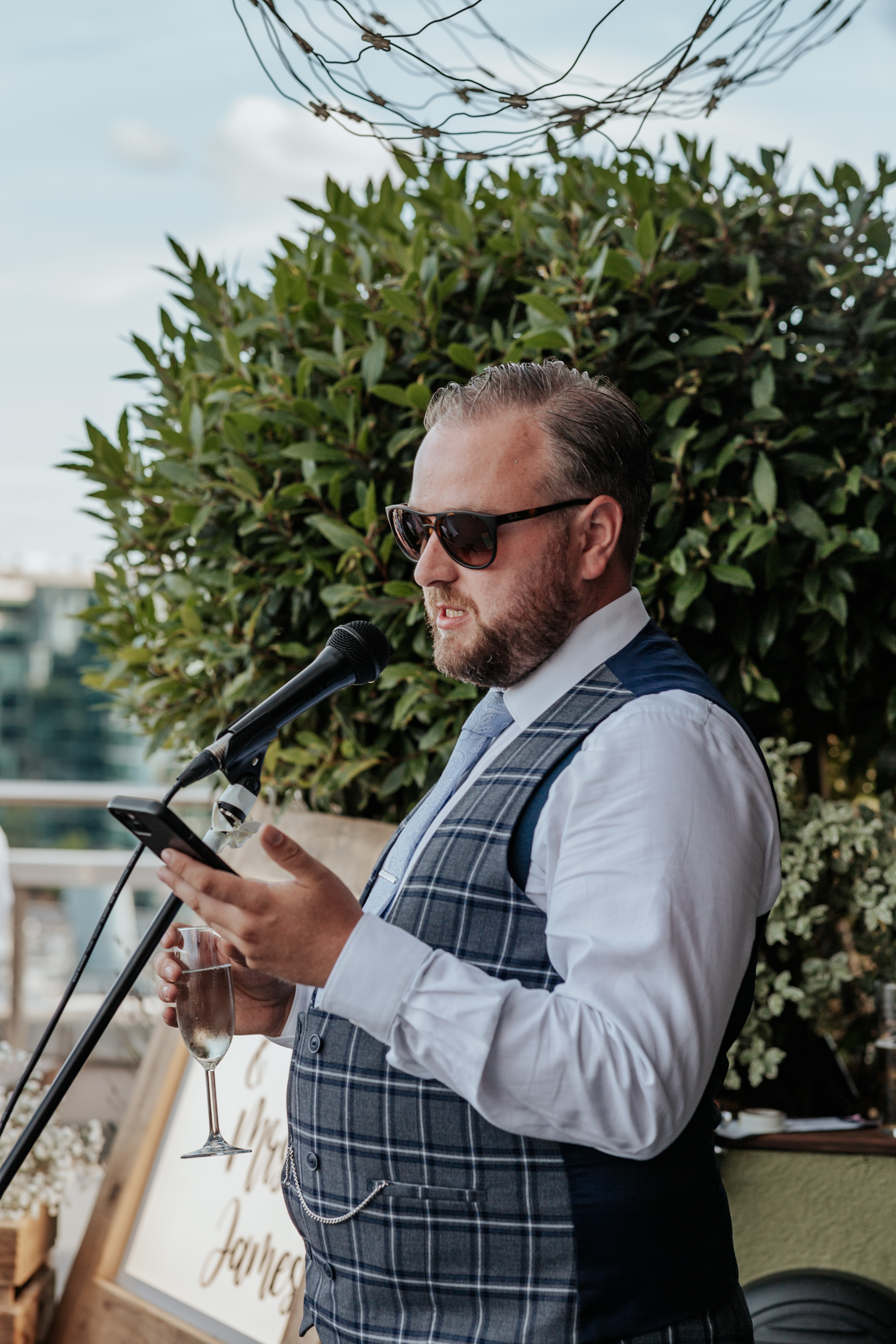 HannahSam25_07-413 Best man does his speech on the rooftop terrace of a London bar