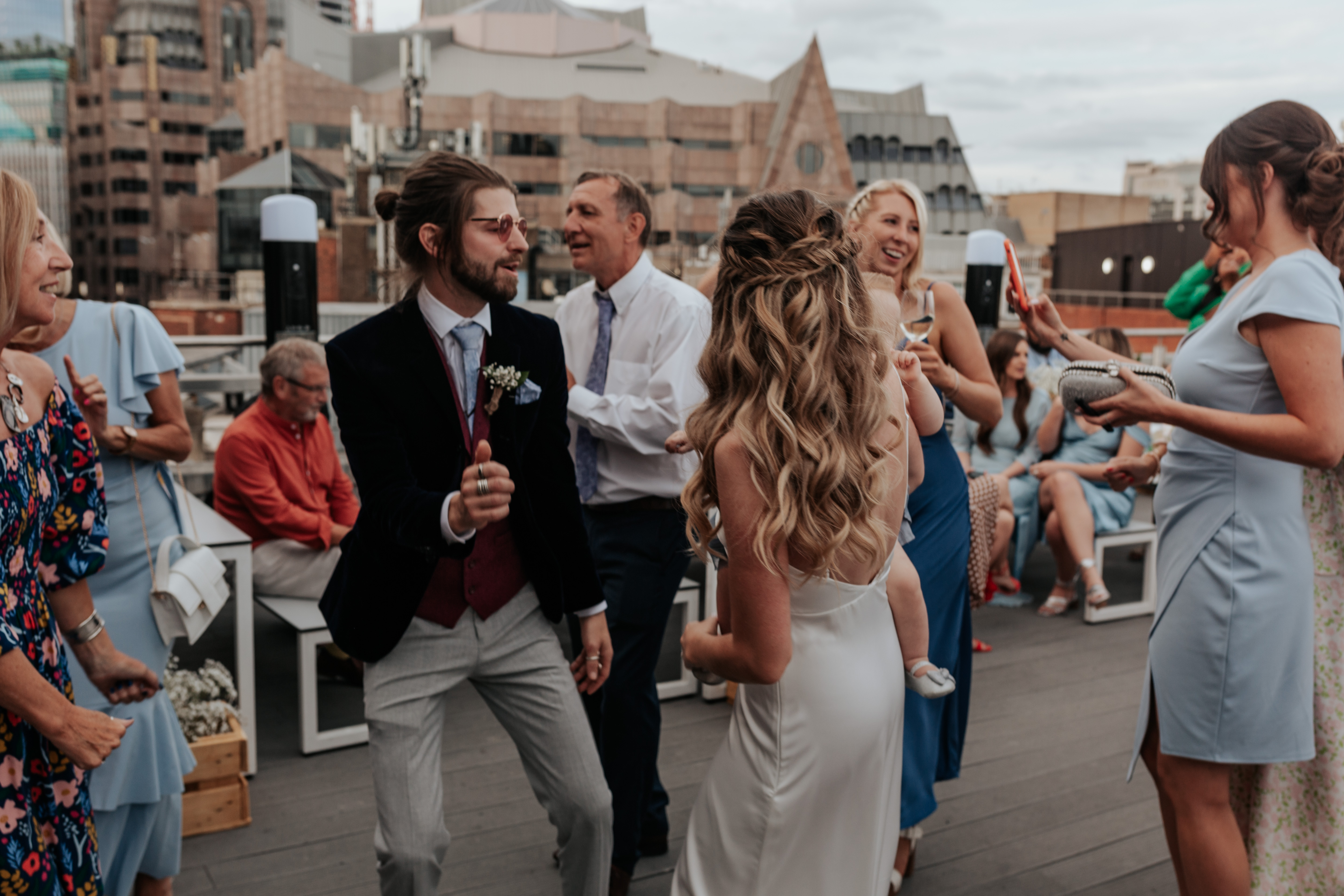 HannahSam25_07-545 Bride and groom dance together on the rooftop terrace of a London bar