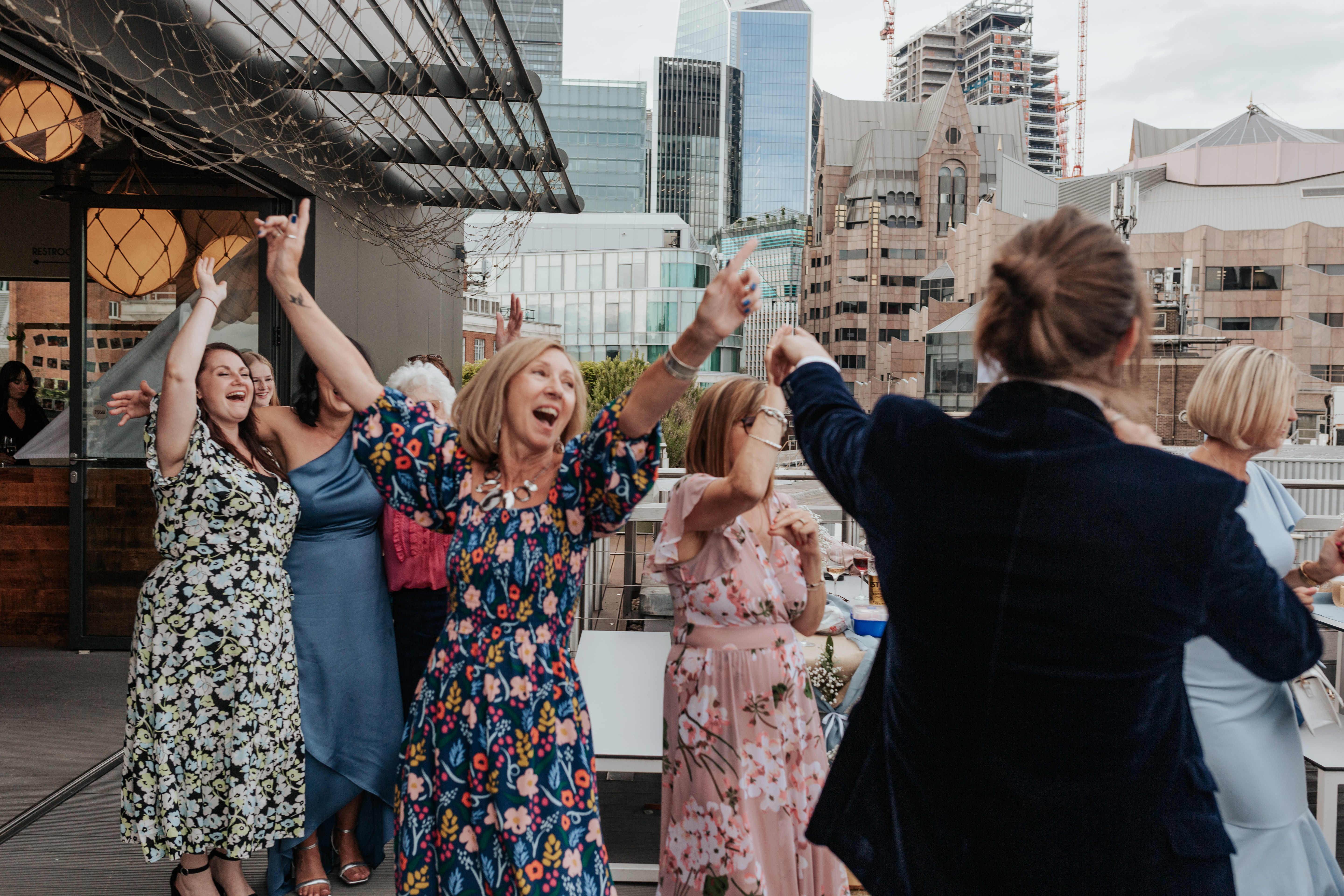 HannahSam25_07-548 Groom dances with his mum on the rooftop terrace of a London bar