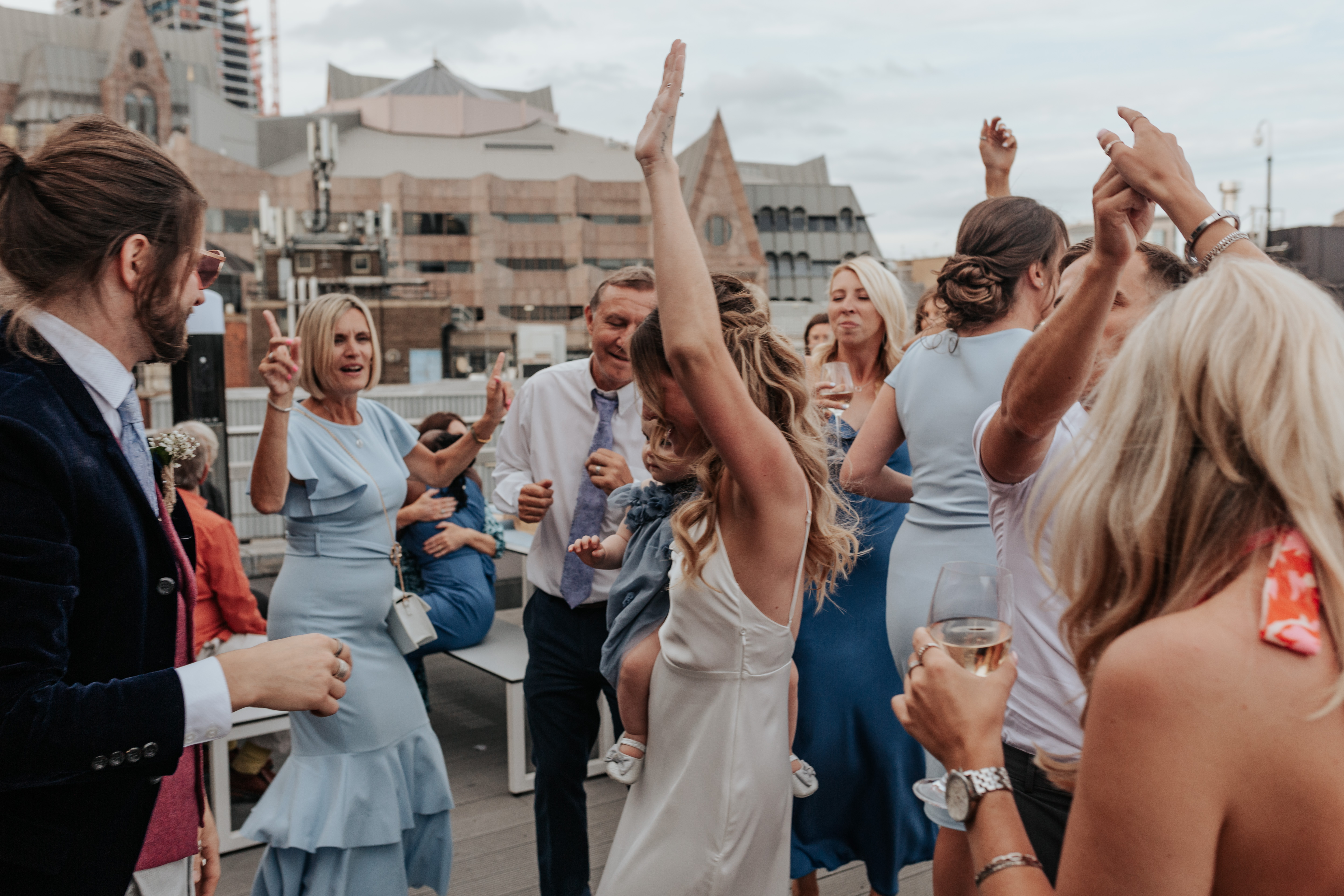HannahSam25_07-549 Bride dances with her daughter on the rooftop terrace of a London bar
