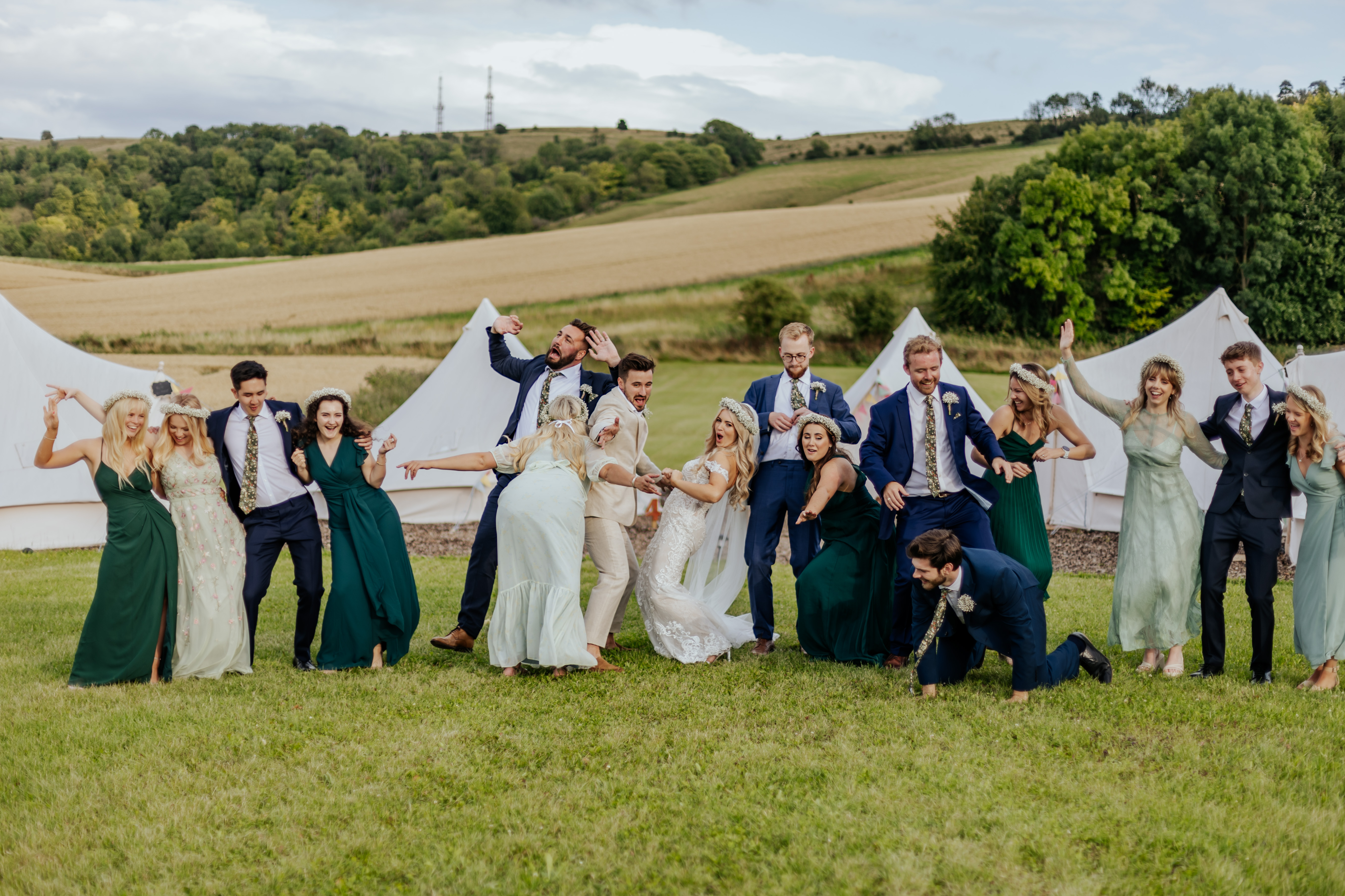 Wedding party strike a pose outside of Wellington Barn's glamping pods
