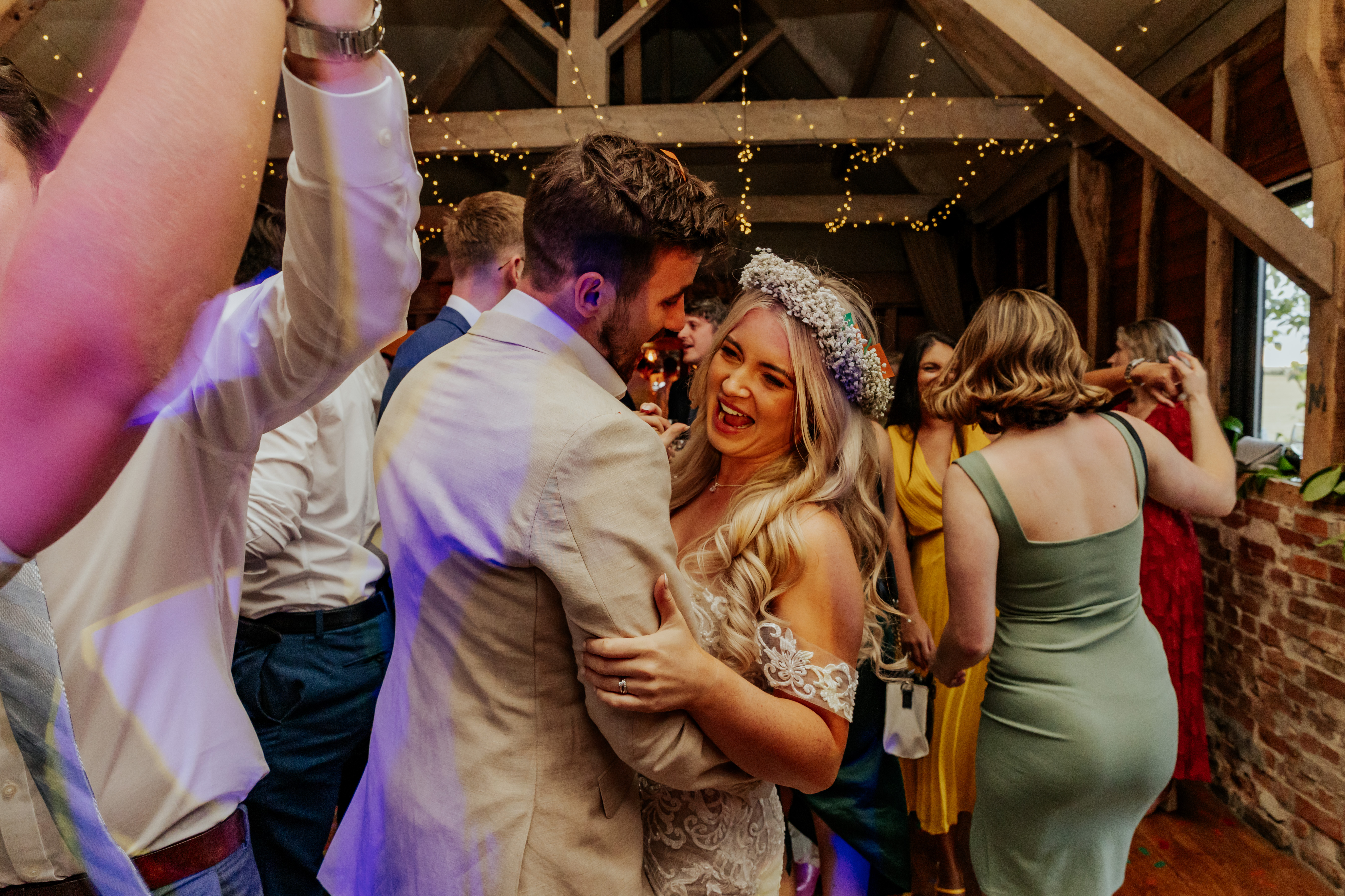 Bride and groom laugh and dance together