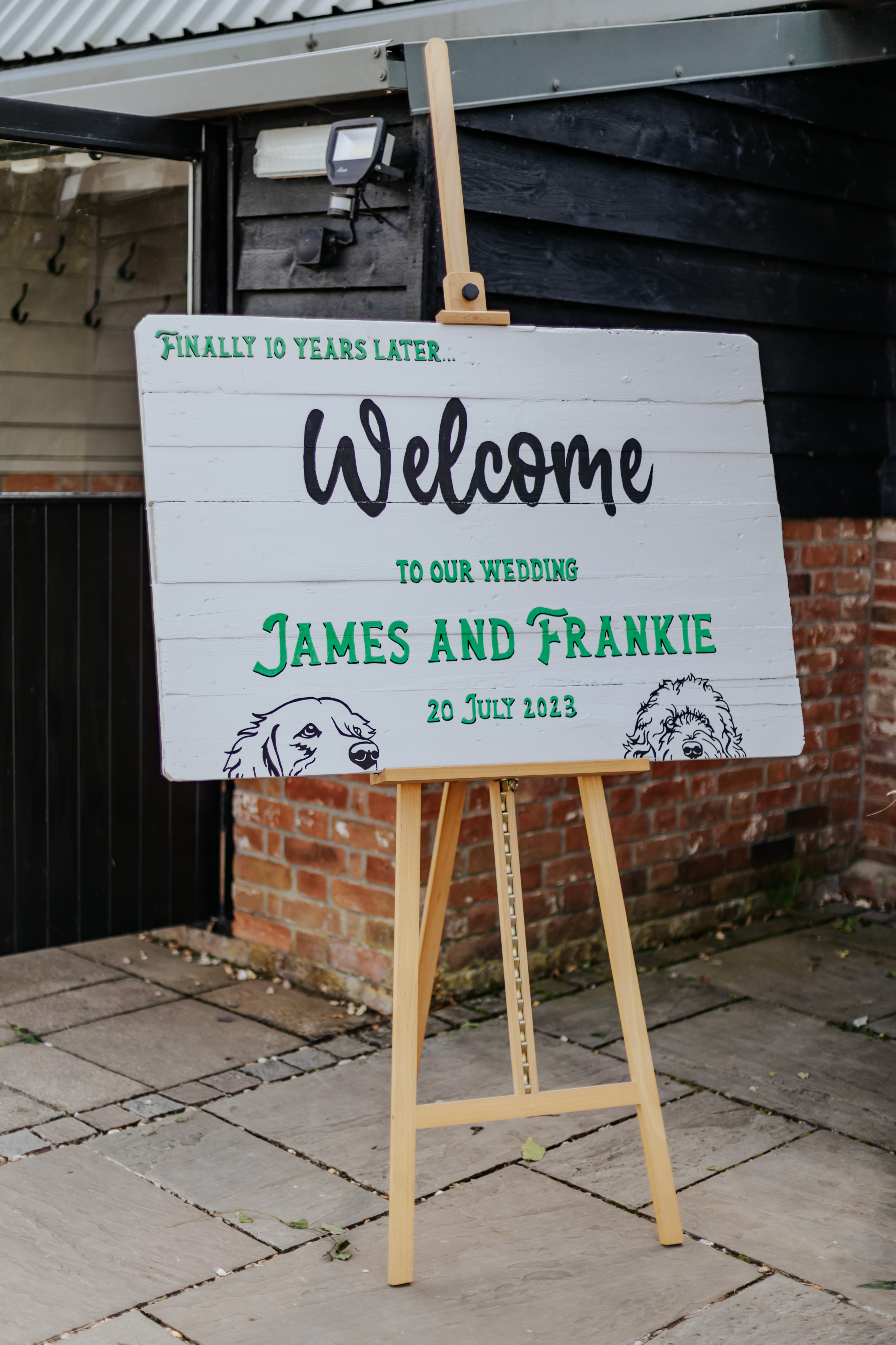 A pub-style sign that says 'welcome to our wedding, James and Frankie'