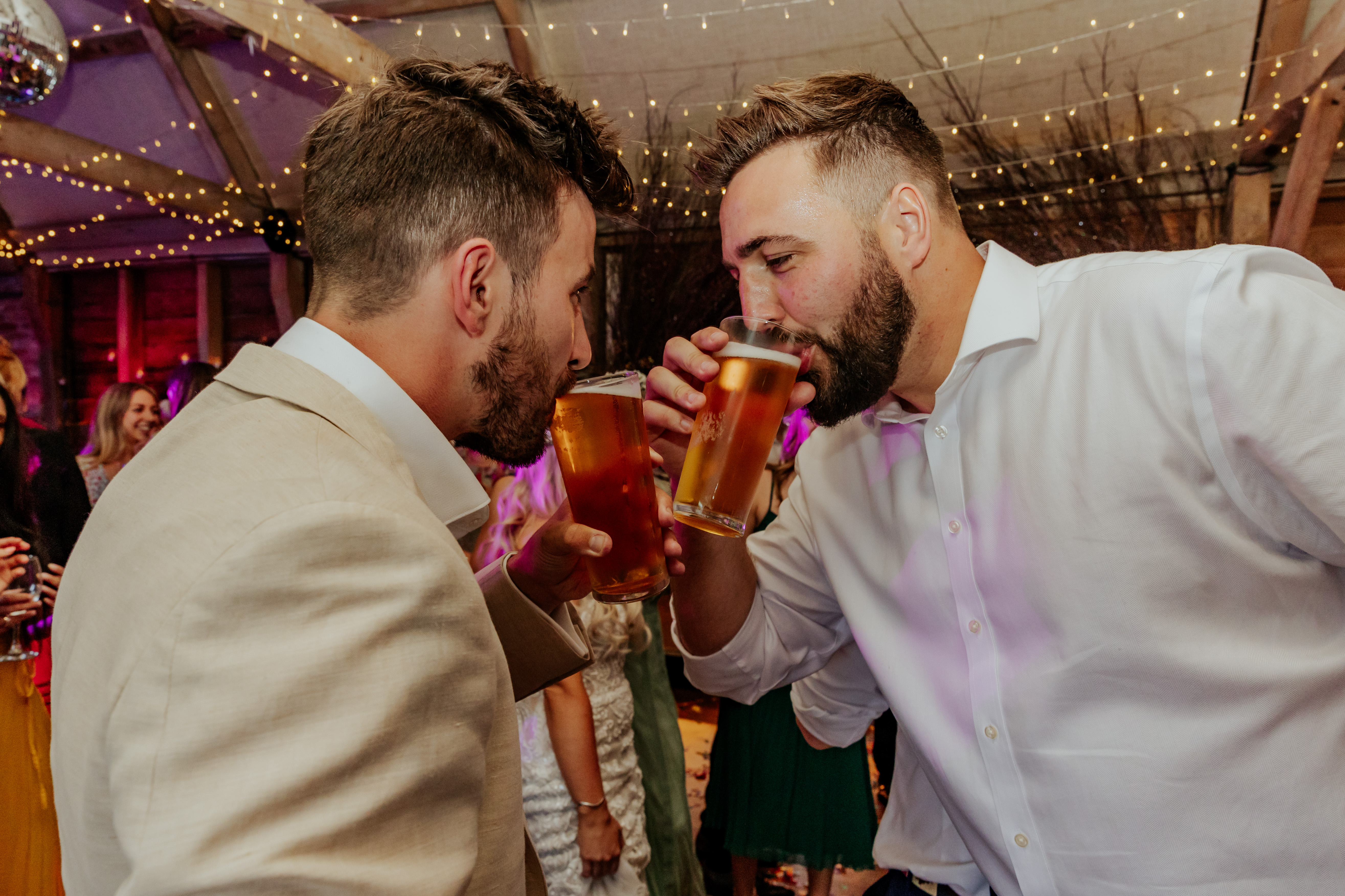 The groom sips a pint with his brother